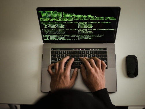 A man writing on laptop
